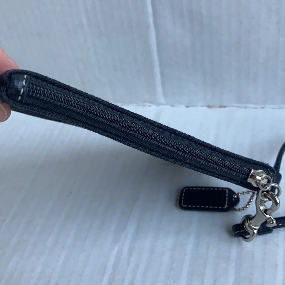 Coach black signature C mini wristlet.